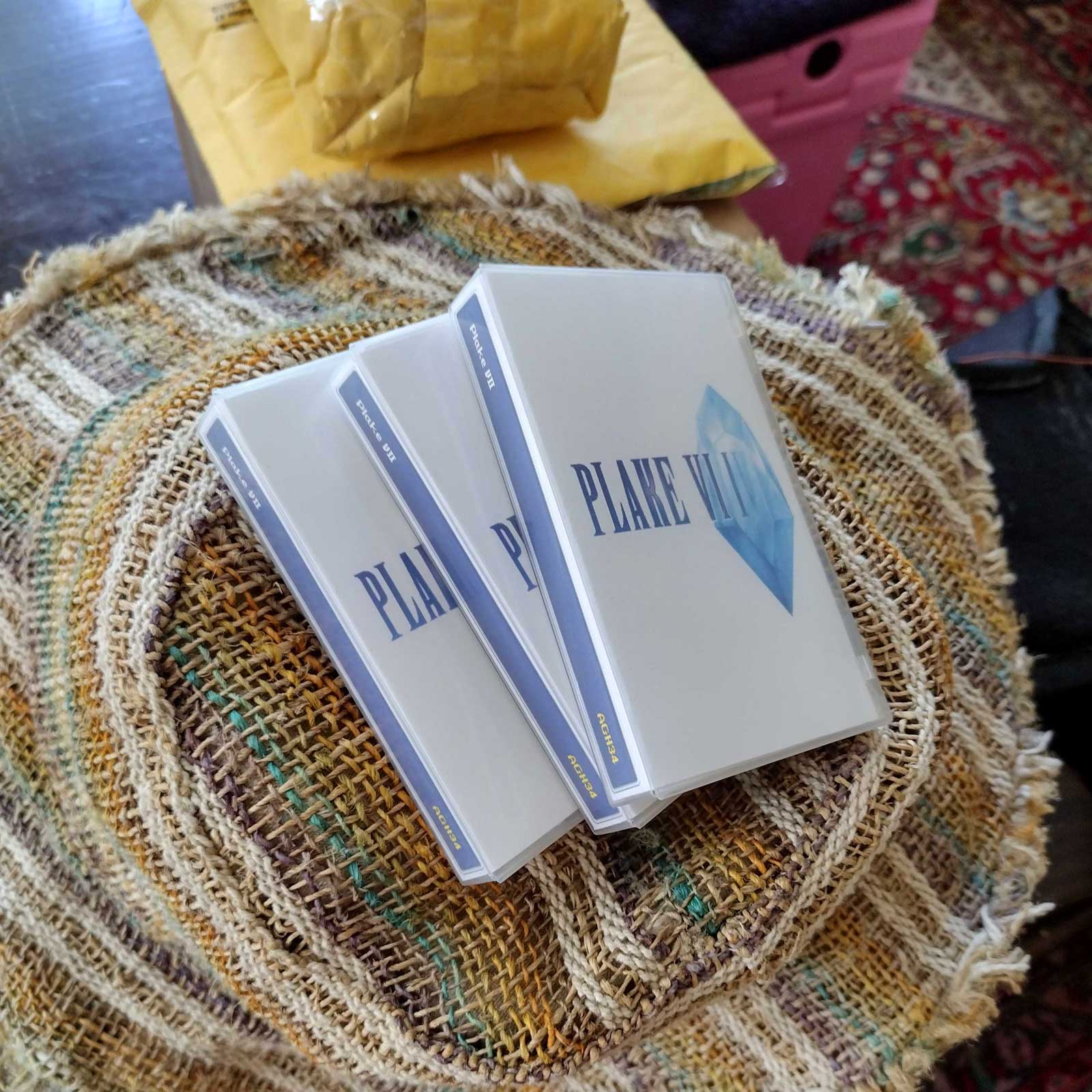 a photo of some Plake VII cassettes sitting on a colorful straw hat