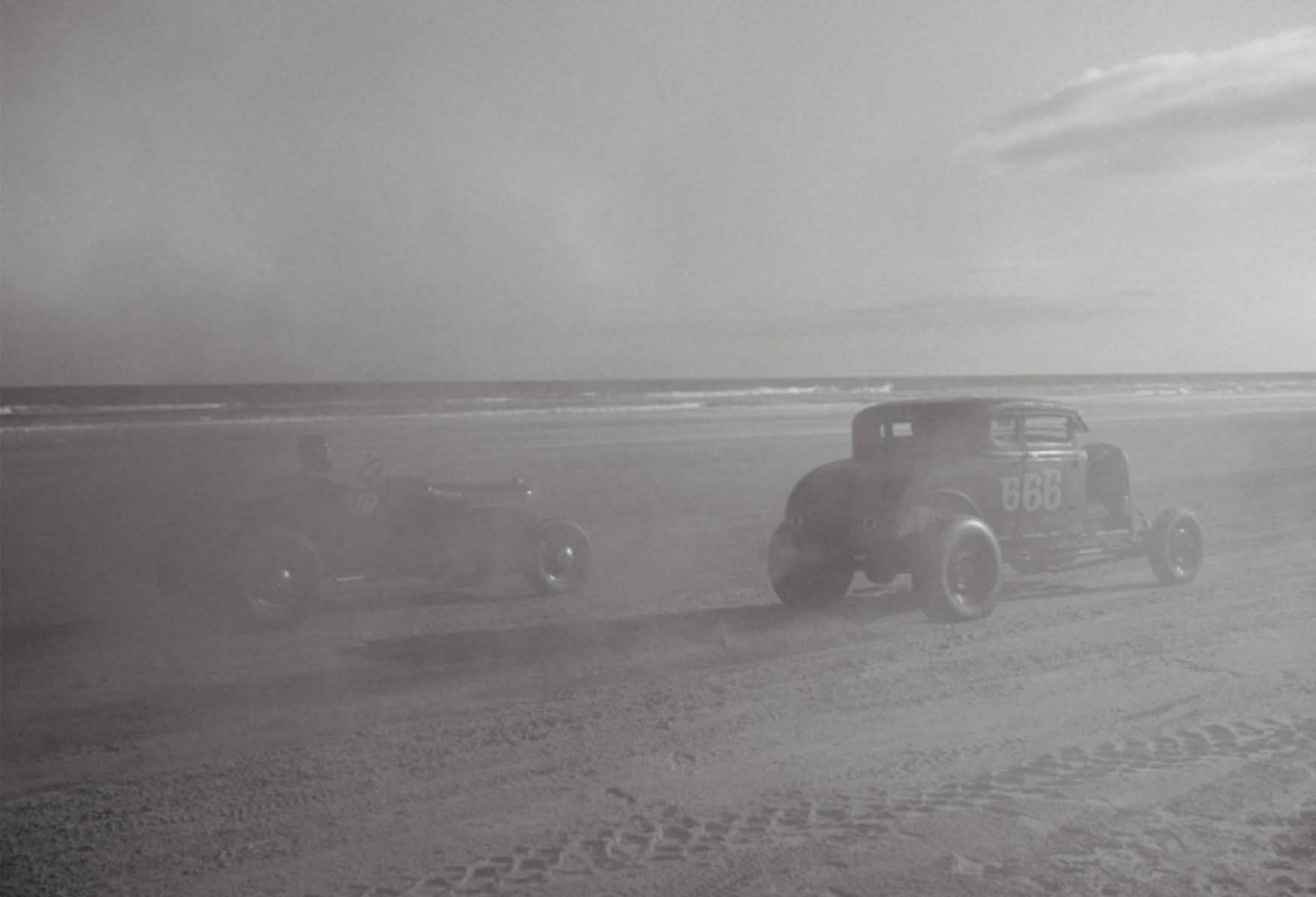 black and white background photography of a car racing on the beach